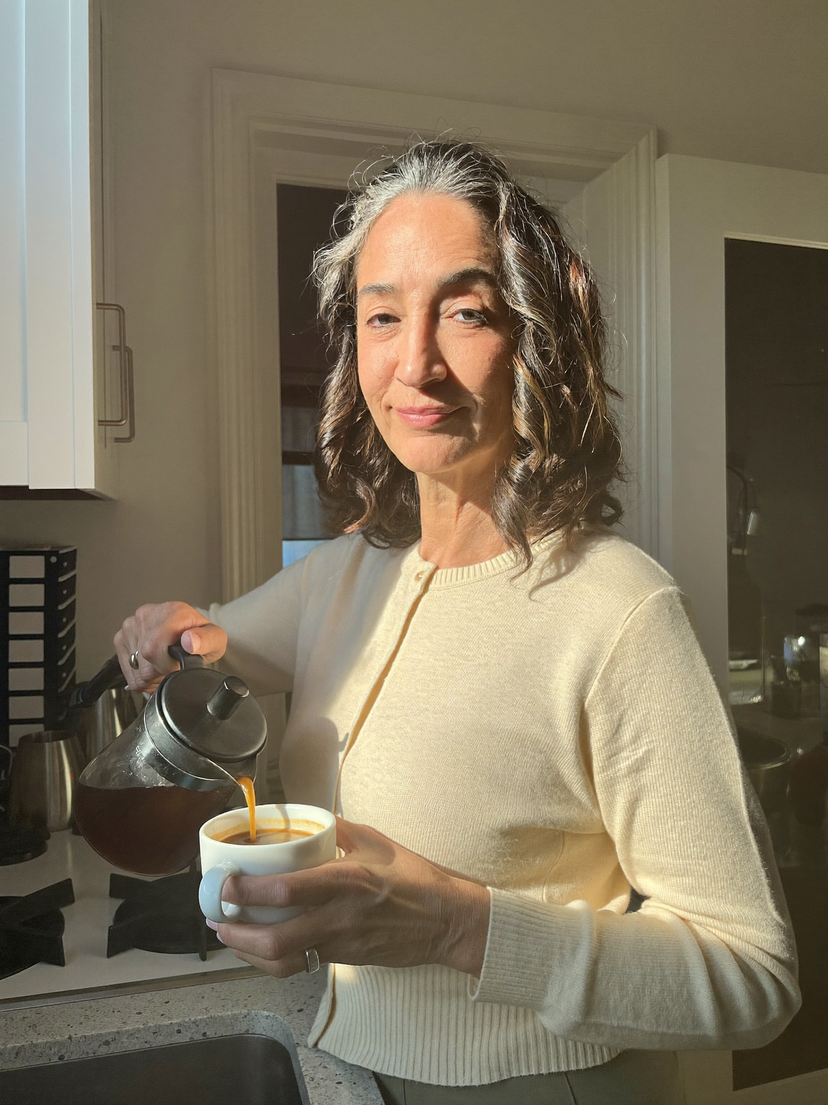 Woman pouring coffee, steady morning